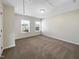 Upstairs bedroom with two windows and neutral decor at 9 Oxmoor Dr, Durham, NC 27703