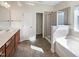 Bathroom with double vanity, shower, and bathtub at 9 Oxmoor Dr, Durham, NC 27703