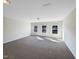Upstairs bedroom with three windows and neutral decor at 9 Oxmoor Dr, Durham, NC 27703