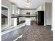 Modern kitchen with white cabinets, island, and stainless steel appliances at 9 Oxmoor Dr, Durham, NC 27703