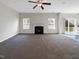 Spacious living room featuring a fireplace and carpet flooring at 9 Oxmoor Dr, Durham, NC 27703