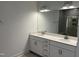 Double vanity bathroom with white cabinets and a large mirror at 1732 Red Elm Lane, Homesite 78, Fuquay Varina, NC 27526