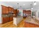 Large kitchen with granite countertops, stainless steel appliances, and hardwood floors at 206 Felspar Way, Cary, NC 27518