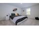 Stylish bedroom with a king-size bed, modern nightstands, and artwork at 2141 Wildwind Dr, Graham, NC 27253