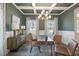 Elegant dining room with green walls and modern chandelier at 167 Pretty Run Branch Ln, Wendell, NC 27591