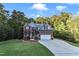 Two story home with brick and gray siding, two car garage, and landscaping at 319 River Knoll Dr, Clayton, NC 27527