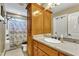 Bathroom with wood cabinets and shower/tub combo at 319 River Knoll Dr, Clayton, NC 27527
