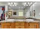 Double vanity bathroom with granite countertop and large mirror at 319 River Knoll Dr, Clayton, NC 27527