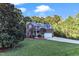 Two story home with brick and gray siding, two car garage, and landscaping at 319 River Knoll Dr, Clayton, NC 27527