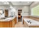 Double vanity bathroom with granite countertop and soaking tub at 319 River Knoll Dr, Clayton, NC 27527