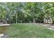 Large backyard with shed and lush trees at 319 River Knoll Dr, Clayton, NC 27527