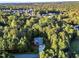 Aerial view of house showcasing wooded setting and neighborhood at 319 River Knoll Dr, Clayton, NC 27527