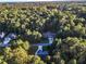 Aerial view of house among other homes in a wooded area at 319 River Knoll Dr, Clayton, NC 27527