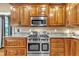 Stainless steel range and double oven in a kitchen with wood cabinets at 319 River Knoll Dr, Clayton, NC 27527