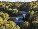 Aerial view of house nestled in wooded lot at 319 River Knoll Dr, Clayton, NC 27527