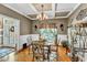 Bright dining room features a glass-top table, chandelier, and hardwood floors at 319 River Knoll Dr, Clayton, NC 27527