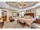 Large bedroom with king bed, seating area, and view into living room at 319 River Knoll Dr, Clayton, NC 27527