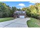 Two story home with brick and gray siding, two car garage, and landscaping at 319 River Knoll Dr, Clayton, NC 27527