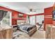 Red-walled bedroom with a double bed and built-in desk at 319 River Knoll Dr, Clayton, NC 27527