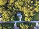 Aerial view of house situated in a wooded area near other homes at 319 River Knoll Dr, Clayton, NC 27527