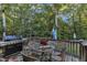 Private deck with wooded views, seating area, and grill at 319 River Knoll Dr, Clayton, NC 27527