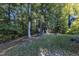Spacious backyard with a fire pit and storage shed at 319 River Knoll Dr, Clayton, NC 27527