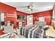 Red-walled bedroom with a double bed and a desk at 319 River Knoll Dr, Clayton, NC 27527
