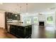 Open concept kitchen with large island, granite countertops, and dark cabinetry at 169 Sage Ln # 012, Four Oaks, NC 27524