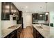 Modern kitchen with granite countertops, stainless steel appliances, and dark cabinetry at 169 Sage Ln # 012, Four Oaks, NC 27524