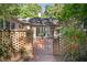 Brick house with ornate gate and landscaped walkway at 675 Whitehurst, Pittsboro, NC 27312