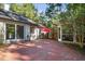 Brick patio with seating area, umbrella, and access to the house at 675 Whitehurst, Pittsboro, NC 27312