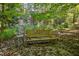 Wooden bench in a serene, wooded setting at 675 Whitehurst, Pittsboro, NC 27312