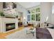 Bright living room features a fireplace and ample natural light at 675 Whitehurst, Pittsboro, NC 27312