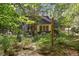 House view from backyard with lush garden at 675 Whitehurst, Pittsboro, NC 27312
