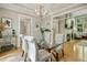 Bright dining room with a glass-top table and hardwood floors at 675 Whitehurst, Pittsboro, NC 27312