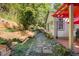 Stone path leads to a charming pergola and patio area at 675 Whitehurst, Pittsboro, NC 27312