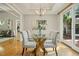 Elegant dining room with glass table, chandelier, and hardwood floors at 675 Whitehurst, Pittsboro, NC 27312
