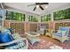 Relaxing screened porch with wicker furniture and brick flooring at 675 Whitehurst, Pittsboro, NC 27312