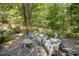 Stone patio with seating area in wooded setting at 675 Whitehurst, Pittsboro, NC 27312