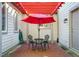 Cozy patio with red umbrella and brick pavement at 675 Whitehurst, Pittsboro, NC 27312