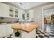 Kitchen island with butcher block countertop and white cabinets at 675 Whitehurst, Pittsboro, NC 27312