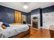 Bright bedroom featuring a fireplace and hardwood floors at 26 Oak St, Roxboro, NC 27573