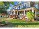 Large two-story house with a wrap-around porch and brick accents at 26 Oak St, Roxboro, NC 27573