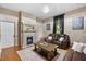 Spacious living room with hardwood floors, fireplace and two sofas at 26 Oak St, Roxboro, NC 27573