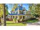 Two-story craftsman home with a metal roof, large porch, and landscaped lawn at 26 Oak St, Roxboro, NC 27573