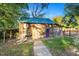 Charming rustic workshop with metal roof and stone pathway at 26 Oak St, Roxboro, NC 27573