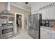 Kitchen with stainless steel appliances and white cabinets at 26 Oak St, Roxboro, NC 27573