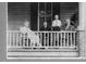 Black and white photo of a Gathering on their porch at 26 Oak St, Roxboro, NC 27573