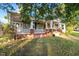 Large two-story house with a wrap-around porch and brick accents at 26 Oak St, Roxboro, NC 27573
