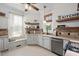 Modern kitchen with stainless steel appliances and wooden shelves at 26 Oak St, Roxboro, NC 27573
